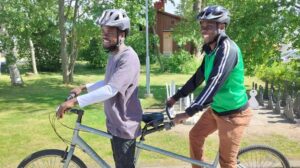 two men on a tandem bike